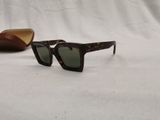 a close up of a pair of sunglasses on a white surface