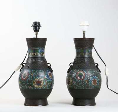 pair of asian vases with floral designs on them on a white surface