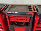 three red and black tool boxes sitting next to each other in a garage