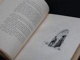 an open book with a drawing of a man and a woman holding an umbrella