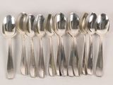 six spoons and six spoons on a white surface
