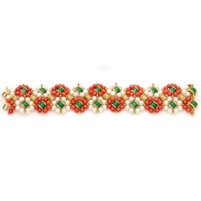 a close up of a bracelet with red and green beads