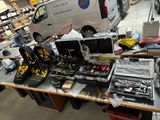 a table with a lot of electronics and tools on it