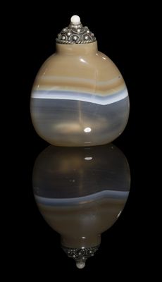 a picture of a glass vase with a black background