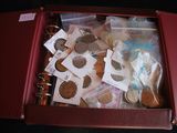 a red suitcase filled with coins and other items