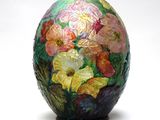 a colorful vase with flowers painted on it on a white background