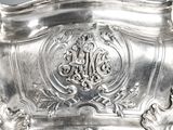 a silver plate with a decorative design on it