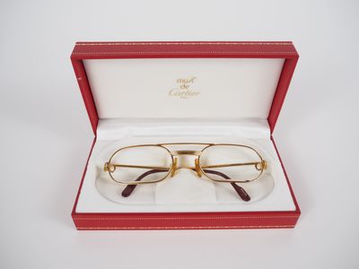 a pair of glasses in a red box on a white surface