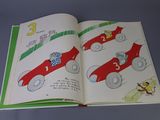 an open book with a picture of a race car on it