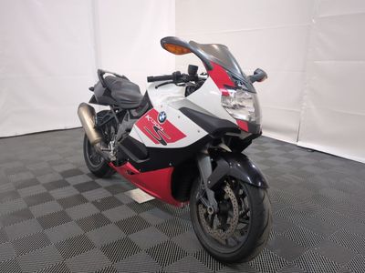 a red and white motorcycle parked on a black and white checkered floor