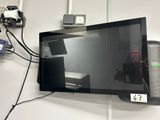 a flat screen tv hanging on the wall next to a charger