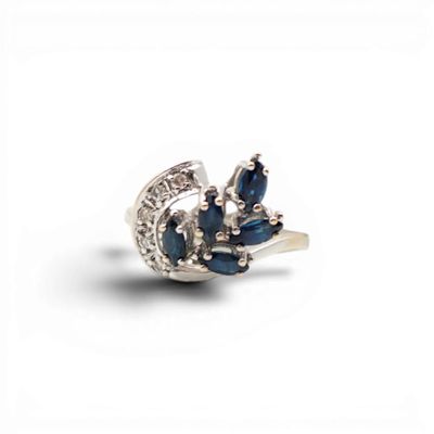 a close up of a ring with blue stones on it