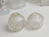 two glass vases and a glass salt and pepper shaker on a table