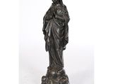 a bronze statue of a woman holding a child