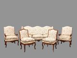 six chaises et un canapé alignés sur un fond gris