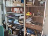 a room with a lot of clutter on the shelves