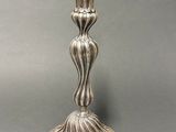 a silver candle that is sitting on a table