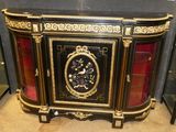 a black and gold sideboard with a clock on it