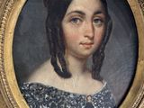 portrait of a young girl in a blue dress in a gold frame