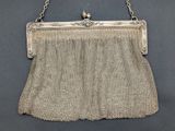 an antique silver mesh purse with a chain handle