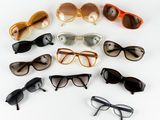 several pairs of sunglasses are arranged in a circle on a white surface