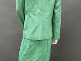 a mannequin wearing a green suit and skirt on a mannequin mannequin mannequin mannequin mannequin mannequin manne