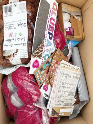 a cardboard box filled with assorted items for sale