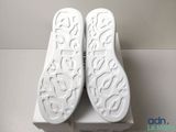the pair of white shoes are sitting on top of a white box