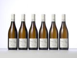 six bottles of white wine lined up in a row
