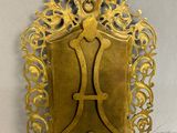 an antique brass plate with a letter h on it