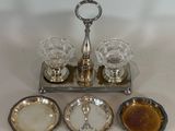 a silver tray with four glasses and a tray with sauces