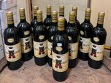many bottles of wine sitting on a wooden table