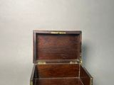 a small wooden box that is open on a table