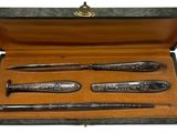 three different types of pens in a wooden case