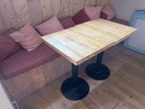 a small table with two chairs and a couch in the corner