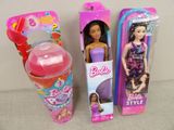 two barbie dolls are next to each other on a table