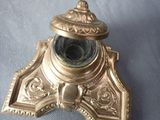a small brass object on a blue cloth