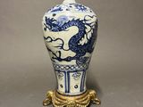 a blue and white vase with a dragon on it