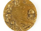 a close up of a gold medal with soldiers on it