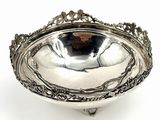 a large silver plate with ornate design on a stand