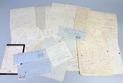 several old papers are piled on top of each other on a table