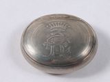 an old silver pocket watch with a crown on the front