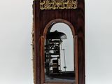 a wooden clock that is sitting on a stand