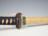 a close up of a sword with a diamond on it