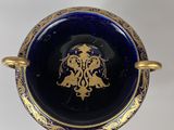 an image of a blue and gold plate with a bird on it