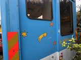 a blue bus that has a star painted on the side of it
