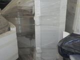 a stack of boxes and a chair in a warehouse