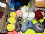 many balls of yarn and scissors on a table