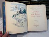 someone is holding a book with a picture of a windmill in it
