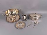 a silver plate with a bowl, spoon, and spoon rest on it